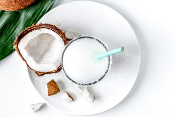 cocktail with coconut on white background top view