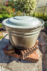 Large enameled pan on a fire in the backyard.