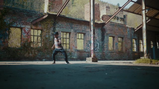 Man dancing in broken down abandoned building