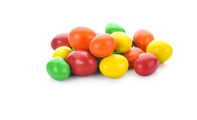 Colorful chocolate coated candies isolated on white background.