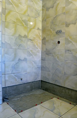 Fastening of a ceramic tile to walls and a floor