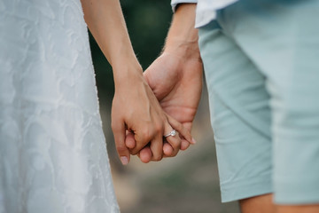 engaged couple holding hands