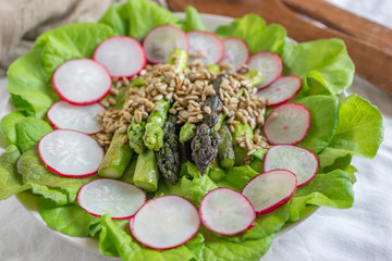 healthy spring salad with asparagus on a table