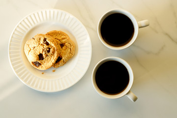 cups of coffees on white marble table in morning light