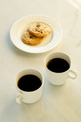 cups of coffees on white marble table in morning light