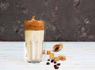 Dalgona coffee. Korean coffee in glasses with brown sugar, coffee on gray background. Drink cold...
