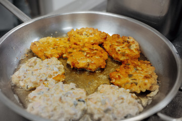 Junk food is cooked in fat in a pan close-up. The problem of obesity and poor nutrition.