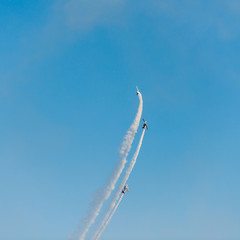Airplanes on airshow. Aerobatic team performs flight at air show