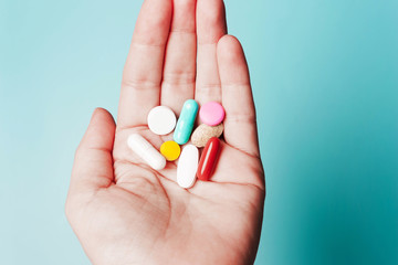 Pills in hand . The concept of health, treatment, disease