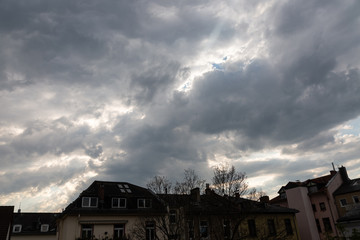 Fototapeta premium Sunset with cloudy dramatic sky over the roofs