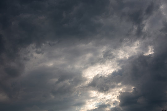 Sunset with cloudy dramatic sky over the roofs