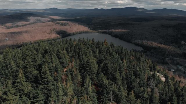 The beautiful Mount Pinacle in Canada by the lake - aerial ascend