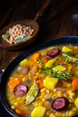 Rustic pea soup with bacon and sausages