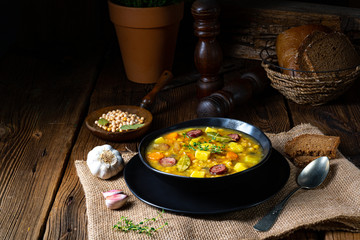 Rustic pea soup with bacon and sausages