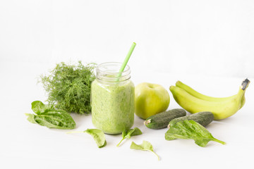 Mixed green smoothie with ingredients