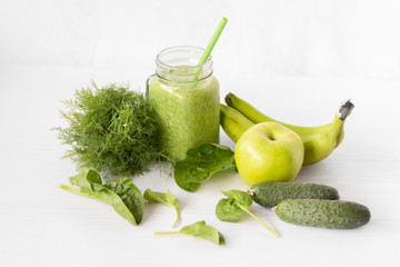 Mixed green smoothie with ingredients