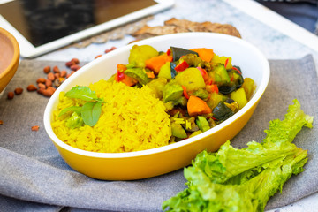 Indian traditional food lunch. Sabji -  vegetables stew with eggplants, potatoes, carrot. Basmati turmeric rice.