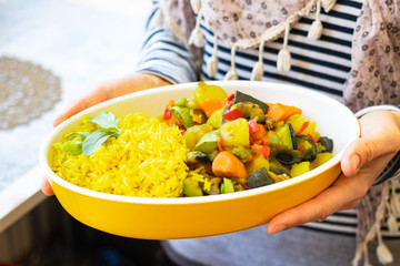 Indian traditional food lunch. Sabji -  vegetables stew with eggplants, potatoes, carrot. Basmati turmeric rice.