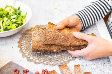 Whole wheat flour, rye brown baked dietary healthy bread. Woman hands