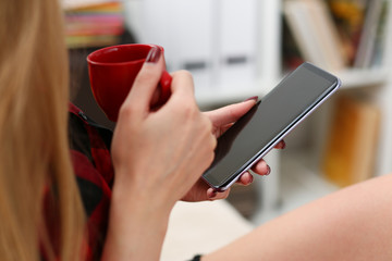woman drinking coffe and look at laptop