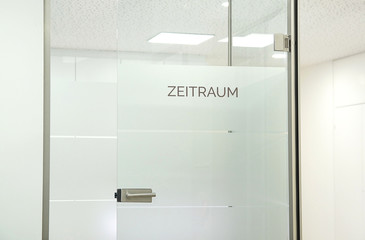 german word ' Zeitraum' engl. 'Waiting Room' text Sign on glass door in a doctor's office, doctor...