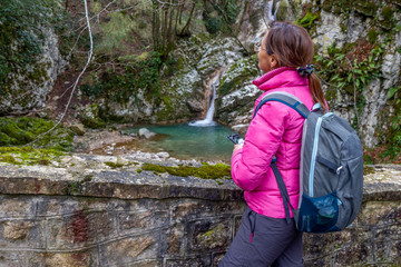 woman hiker photographing waterfall in sassinoro and fog