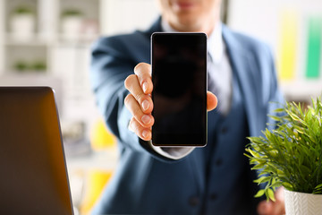 Male arm in suit show in camera phone display