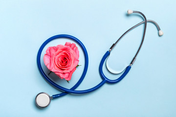 Beautiful heart rose and stethoscope on blue background. Thank you doctor and nurse concept