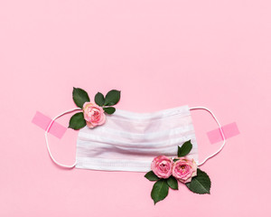 Thanks to Doctor and Nurses concept with medical mask and roses flowers on pink background with...