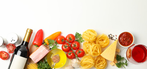 Composition with pasta and ingredients for cooking on white background, top view