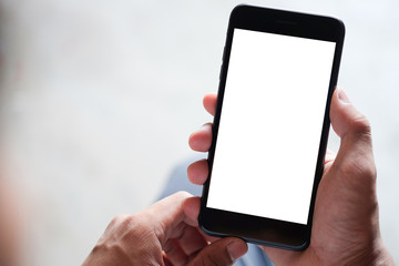 Cropped shot view of man hands holding smart phone with blank copy space screen for your text message or information content, female reading text message on cell telephone during in urban setting. 