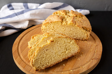 Homemade Irish Soda Bread on a black surface, side view. Close-up.