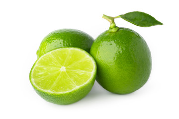 two lime with half and green leaf isolate on white background