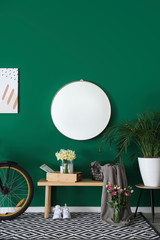Interior of hall with stylish mirror and spring flowers