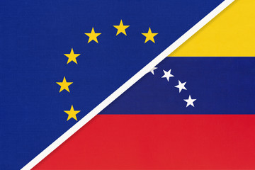 European Union or EU vs Venezuela national flag from textile. Symbol of the Council of Europe association.