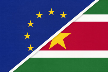 European Union or EU vs Suriname national flag from textile. Symbol of the Council of Europe association.