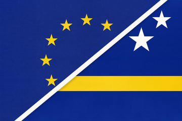 European Union or EU vs Curacao national flag from textile. Symbol of the Council of Europe association.