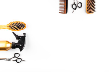 Hairdresser set in beauty salon. Combs, scissors, spray on white desk top-down space for text