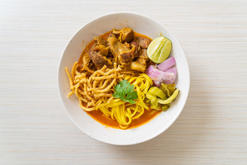 Northern Thai noodle curry soup with braised pork