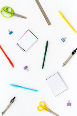 Flat lay stationery set - notebook, pen, sciccors - on white background top view