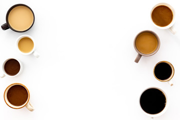 Cups of hot drinks on white background from above frame copy space