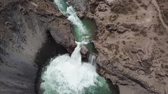 Birds Eye Aerial View of Yeso River Waterfall and Natural Pool in Rocky Canyon Under Andes Mountains, Chile