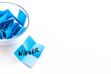 Paper pieces - random winner selection - white desk