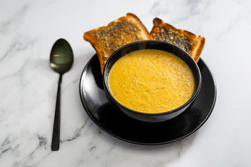 plant-based food, vegan carrot and potato soup with pesto garlic bread