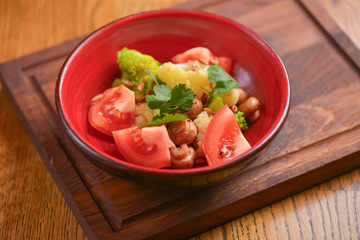 Vegetable salad with tomatoes, pepper, cucumbers, cabbage and mushrooms. Fresh organic veggies. Vegan, vegetarian diet.