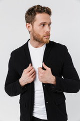 Image of handsome serious man in jacket posing and looking aside