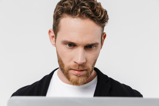Image closeup of handsome focused man working with laptop