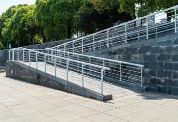 Fotobehang A wheelchair ramp, an inclined plane installed in addition to or instead of stairs © gjp311