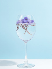 A bouquet of flowers in a wine glass. Creative concept of winemaking.