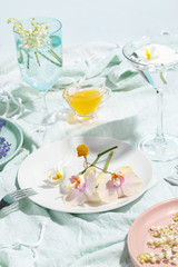 Delicate decorative flowers on plates. Creative concept of table serving and healthy eating